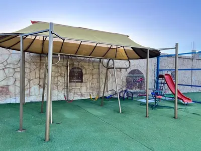 a large tent with swings and a playground at مزرعة وشاليه ادم
