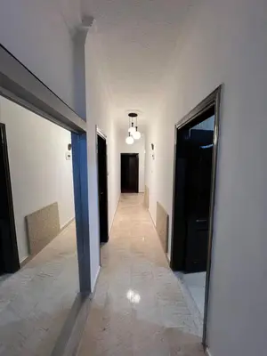 a hallway of a building with a hallway leading to a door at شقه مفروشه in Amman