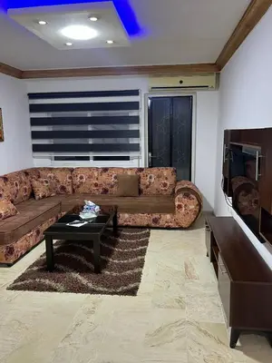a living room with a couch and a coffee table at شقه مفروشه in Amman