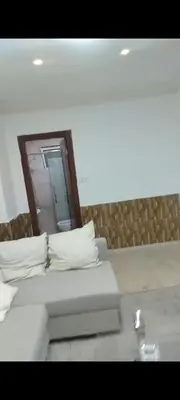 a bed with white pillows and a mirror on the wall at شقه مفروشه in Amman