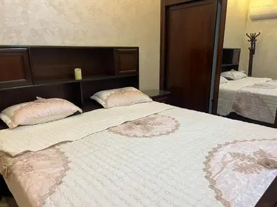 a large bed with two pillows on top of it at No Stars in ‘Urjān al Gharbīyah