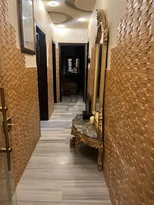 a hallway with a mirror and a bench in a building at No Stars in ‘Urjān al Gharbīyah