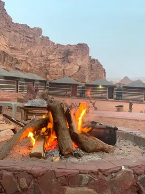 a fire pit in the middle of a desert at Sand Desert Camp in Wadi Rum
