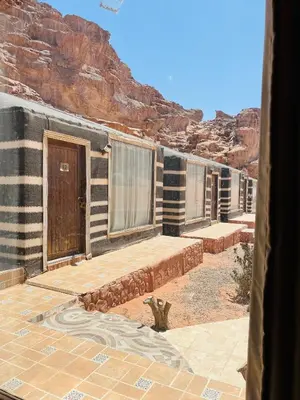 a row of modular homes in the desert at Sand Desert Camp in Wadi Rum