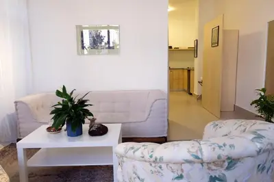 a living room with a couch and a table at Sunny Studio in Amman in Amman