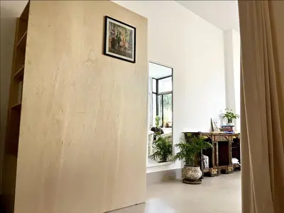 a large wooden wall in a room with a window at Sunny Studio in Amman in Amman