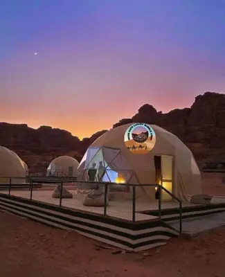 a group of three dome tents in the desert at MARS GATE lUXURY BUBBLE CAMP in Wadi Rum
