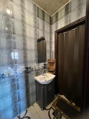 a bathroom with a sink and a mirror at Petra Hospitality in Wadi Musa