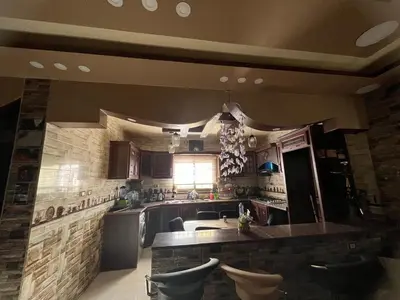 a kitchen with a counter and a counter top at Petra Hospitality in Wadi Musa