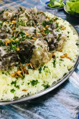 a pizza with mushrooms and rice on a table at Petra Hospitality in Wadi Musa