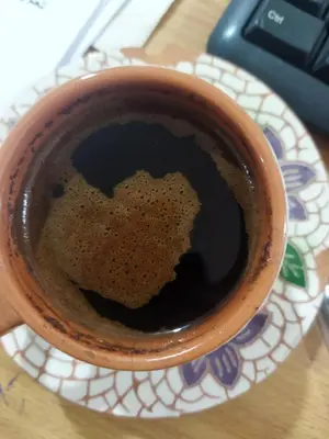 a cup of coffee with a heart in the drink at Petra Hospitality in Wadi Musa