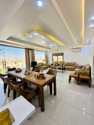 a living room with tables and chairs and a couch at Milano villa & farm in Balīlā