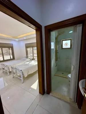a bathroom with a shower and a bedroom with a bed at Milano villa & farm in Balīlā