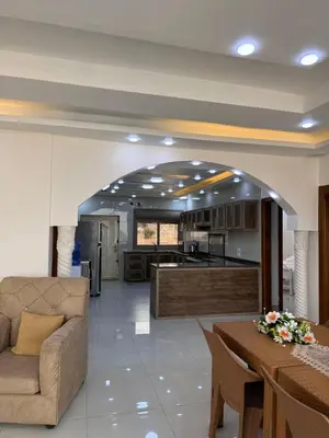 a living room with a couch and a kitchen at Milano villa & farm in Balīlā
