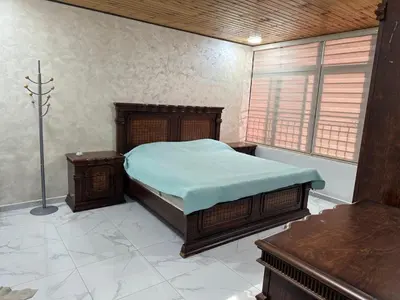 a bedroom with a bed and two tables and a window at New Rooftop 3 bedroom furnished apartment- Super deluxe in Amman