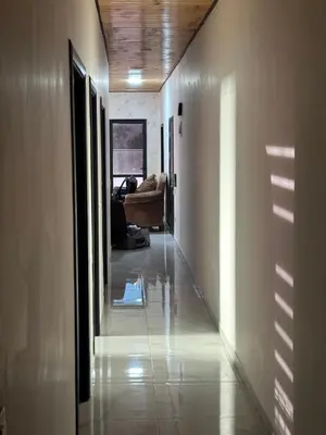 a hallway leading to a living room with a couch at New Rooftop 3 bedroom furnished apartment- Super deluxe in Amman