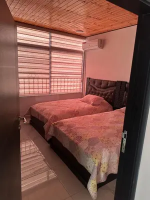 a bedroom with two beds and a window at New Rooftop 3 bedroom furnished apartment- Super deluxe in Amman