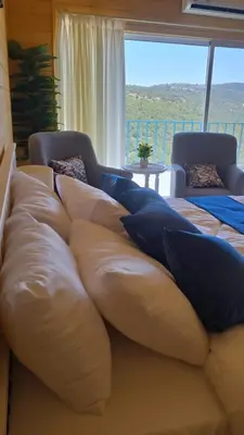 a large couch with pillows on it in a room at Akwakh Alkhair in Ajloun