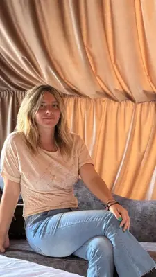 a woman sitting on top of a couch at Rum Rhal Luxury Camp in Aqaba