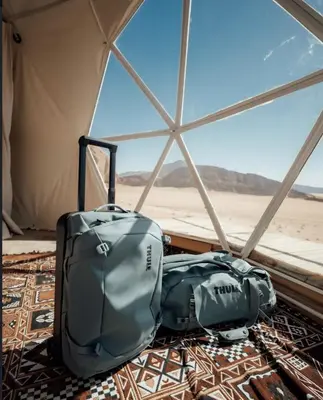 two pieces of luggage sitting inside of a tent at RUM lUXURY SAMA CAMP in Wadi Rum