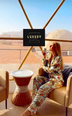 a woman sitting in a chair talking on a cell phone at RUM CROWD DARLiNG LUXURY in Wadi Rum