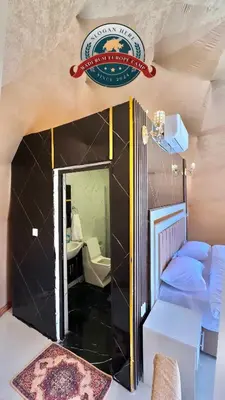 a small room with a mirror and a bed at WADI RUM EUROPE lUXURY CAMP in Wadi Rum