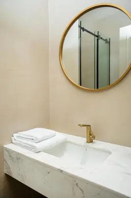 a bathroom with a sink and a mirror at The Boulevard Residences in Amman