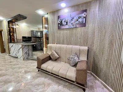 a living room with a couch against a wall at مزرعة وشاليه ادم