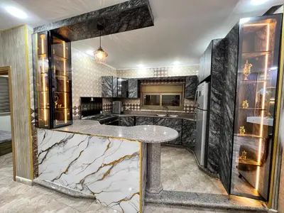a kitchen with a marble counter top in a room at مزرعة وشاليه ادم