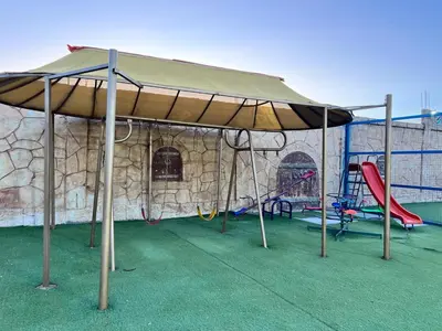 a large tent with swings and a playground at مزرعة وشاليه ادم