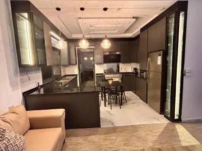 a kitchen and living room with a couch and a table at Luxury comfortable apartment