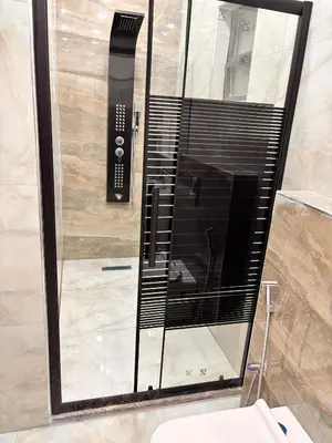 a glass shower in a bathroom with a toilet at Luxury comfortable apartment