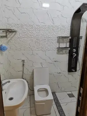 a bathroom with a sink and a toilet and a phone at دار عدنان للشقق الفندقية المفروشة in Al Mafraq