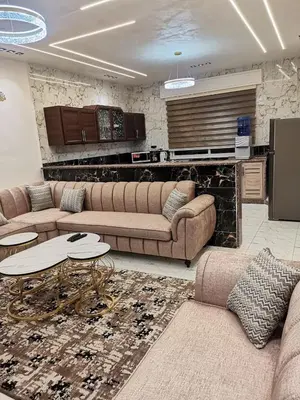 a living room with two couches and a table at دار عدنان للشقق الفندقية المفروشة in Al Mafraq