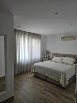a bedroom with a large bed and a window at Villa rooftop with stunning view apartment in Amman