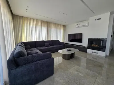 a living room with a couch and a fireplace at Villa rooftop with stunning view apartment in Amman