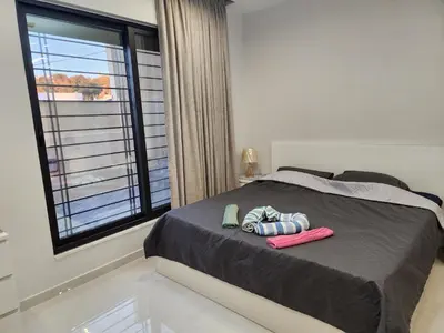a bedroom with a bed with slippers and a window at 3BR Furnished Apartment for Rent - PART OF VILLA in Amman