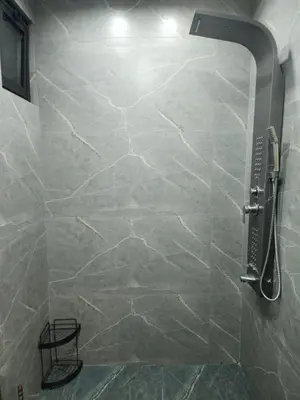 a bathroom with a shower with a stone wall at 3BR Furnished Apartment for Rent - PART OF VILLA in Amman