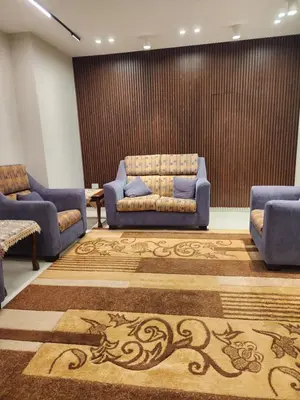 a waiting room with two blue couches and a carpet at 3BR Furnished Apartment for Rent - PART OF VILLA in Amman