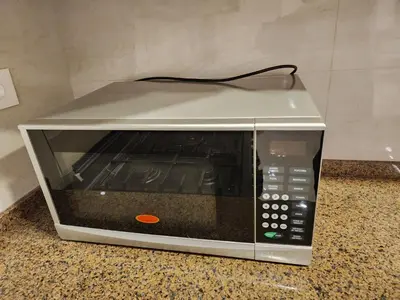 a microwave sitting on top of a counter at 3BR Furnished Apartment for Rent - PART OF VILLA in Amman