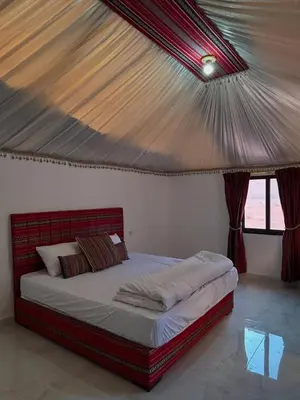 a bedroom with a bed with a roof at Camp in the natural reserve & tours in Aqaba
