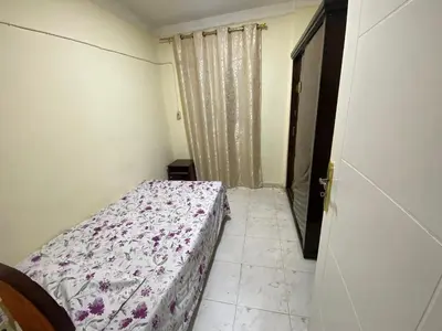 a bedroom with a bed in a room with a window at Yes inn in Bushrá