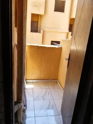 a small room with a tiled floor and an open door at Tamri guest house in Amman