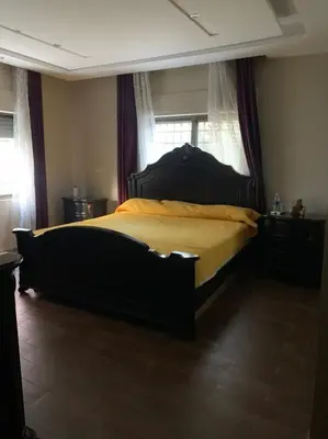 a bedroom with a large bed with yellow sheets at Luxurious 5 bedroom Furnished Villa superb locationفيلا فخمه in Amman