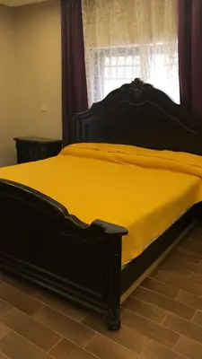 a bedroom with a yellow bed with a window at Luxurious 5 bedroom Furnished Villa superb locationفيلا فخمه in Amman
