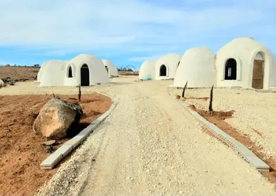 a dirt road in the middle of a desert with domes at Tootya camp