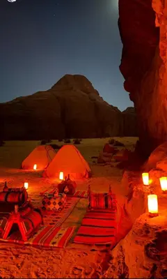 two orange tents in the desert at night at Wadi rum Bubble Bianca luxury in Wadi Rum