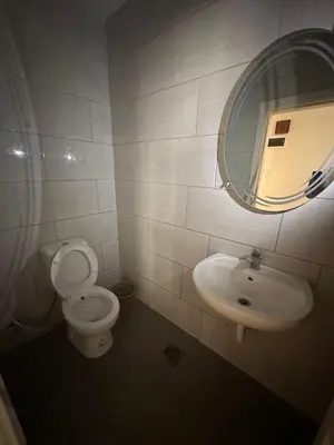 a bathroom with a toilet and a sink and a mirror at الجبيهة 2 نوم aljubiha apartment in Amman