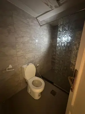a bathroom with a white toilet in a room at الجبيهة 2 نوم aljubiha apartment in Amman