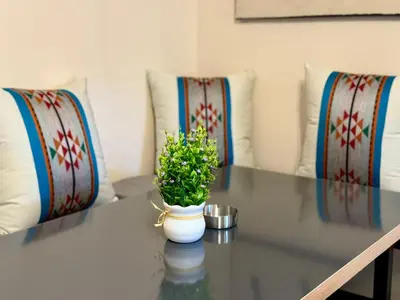 a glass table with a vase with a plant on it at Spacious central apartment in Amman